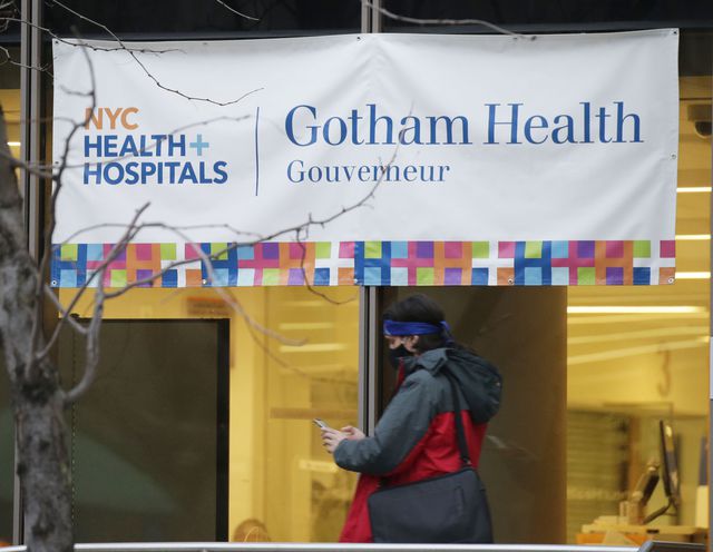 A sign for NYC Health + Hospitals/Gotham Health, one of the sites for coronavirus public vaccinations, hangs above a window at 227 Madison Street in the Lower East Side.